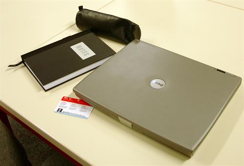 workplace with mobile pc and library card